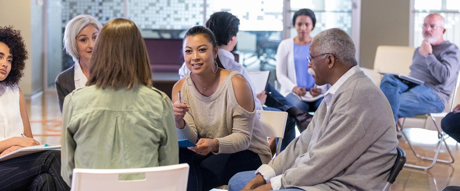 A group of people meeting in a community room.