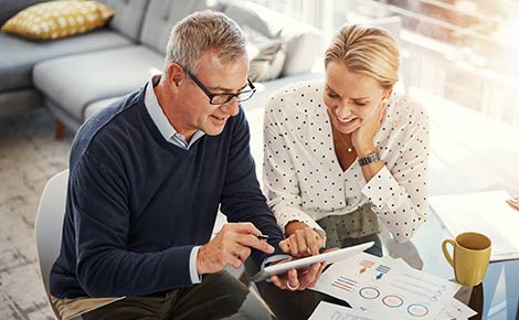 Couple on a tablet looking at their their IRA.